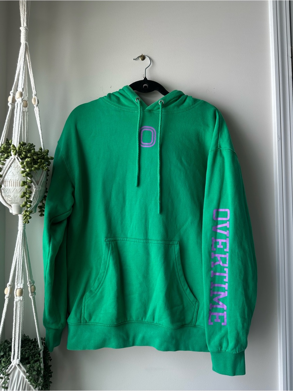 Green Crewneck Hoodie with Purple 'OVERTIME' Sleeve Text
